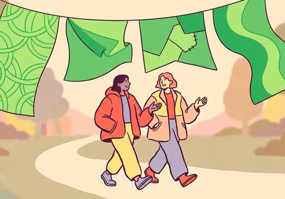 Two friends walking together beneath green flags