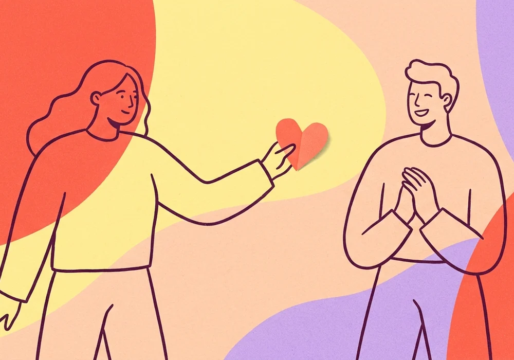 One person offering a heart while the other receives it