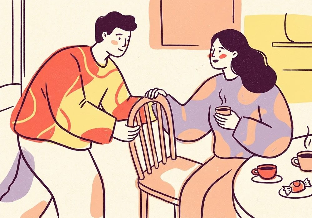 Two people leaning into an attentive conversation over coffee